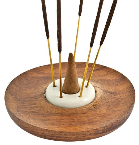 Wooden incense holder with cones and sticks on a white background