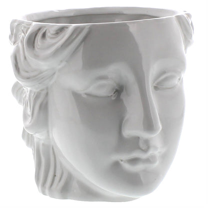 White ceramic vase shaped like a face with a floral design on a white background